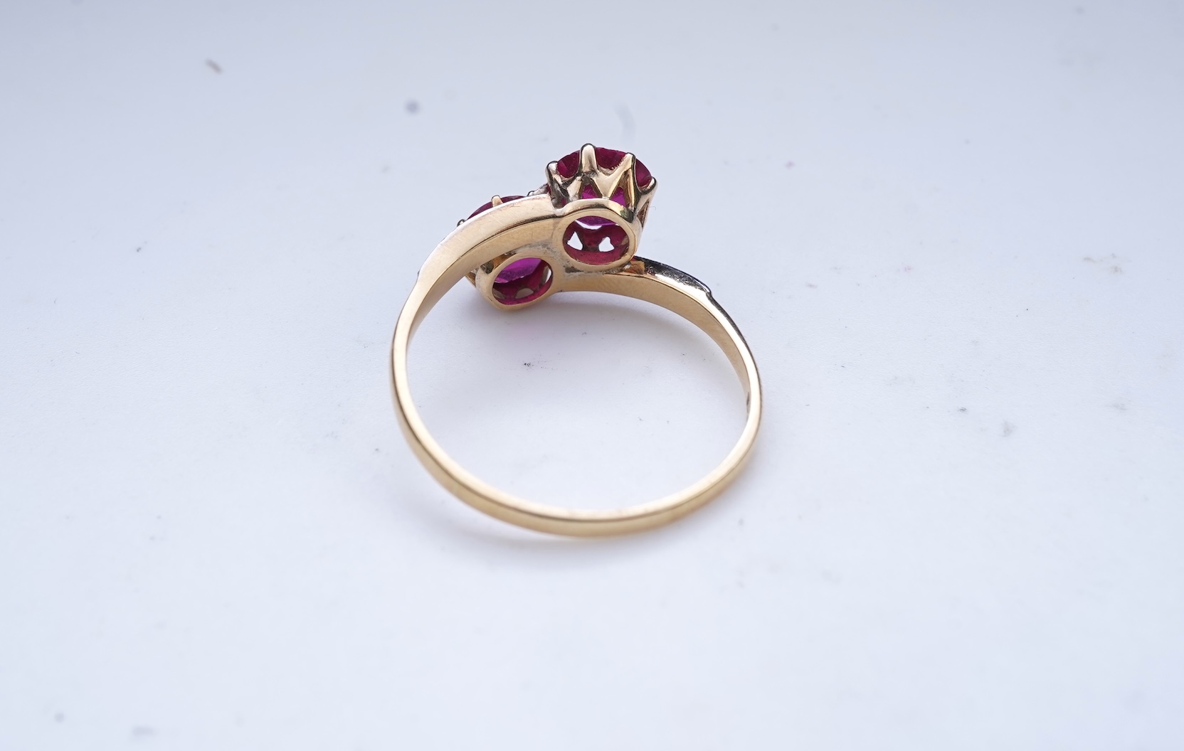 A synthetic ruby and diamond 'toi-et-moi' ring, early 20th century